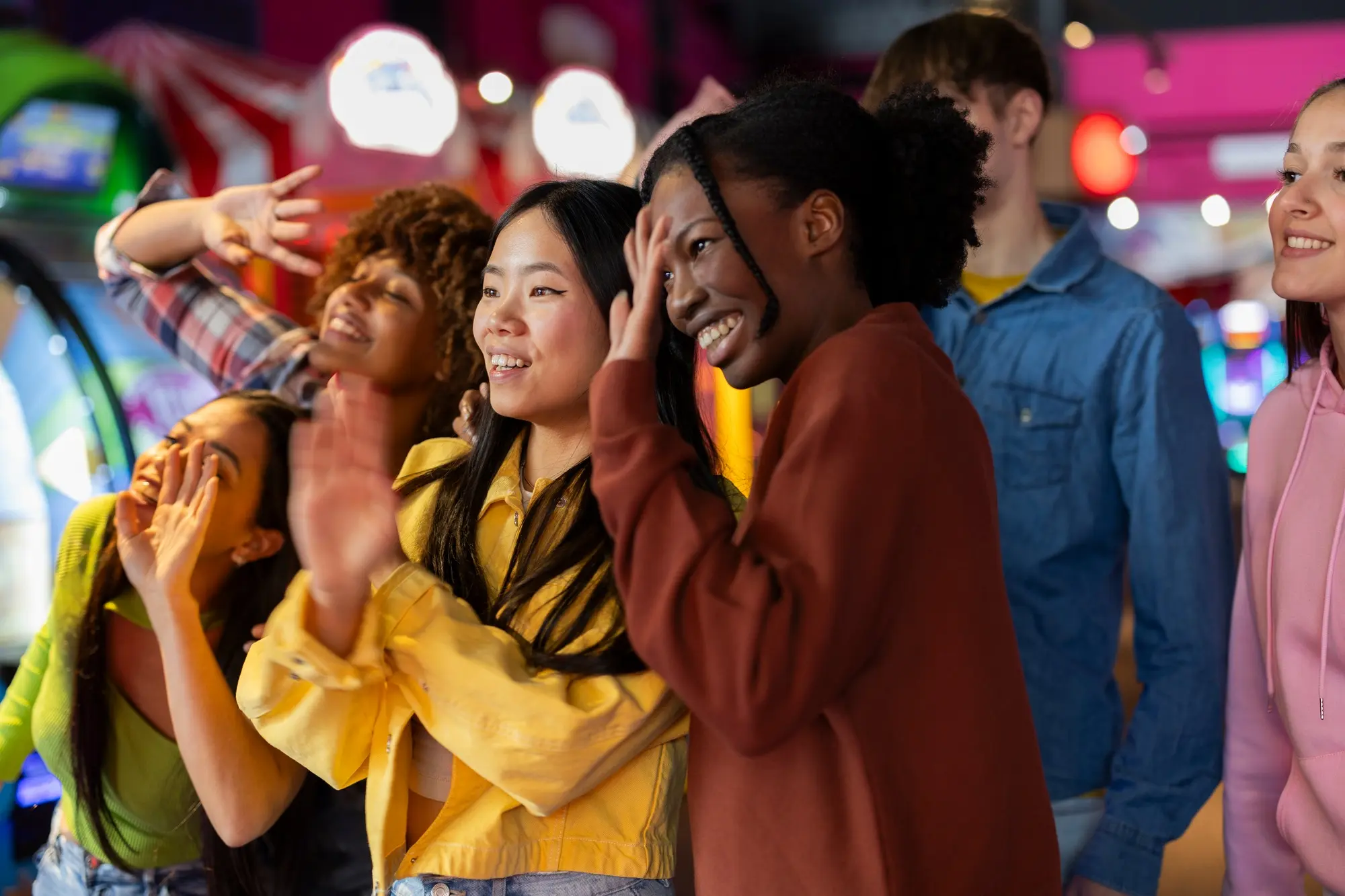 Joyful Friends Playing in a Lively Arcade Environment